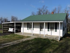 Location! Location! Location!  This cute 2 bdrm, 1 bath sits on .69 acres on a paved quiet country road.  Totally remodeled several years ago.  Nice Kit w/beautiful oak cabinet.  Extra nice BA.  Pretty inter paint, CH&A.  Hrdwd flrs.  Tile flrs in Kit & BA.  Cook stove, refrig, washer & dryer incl.  Metal roof.  Vinyl siding.  Carport. Beautiful view of mtns. Easy drive to town. Harrison Schools