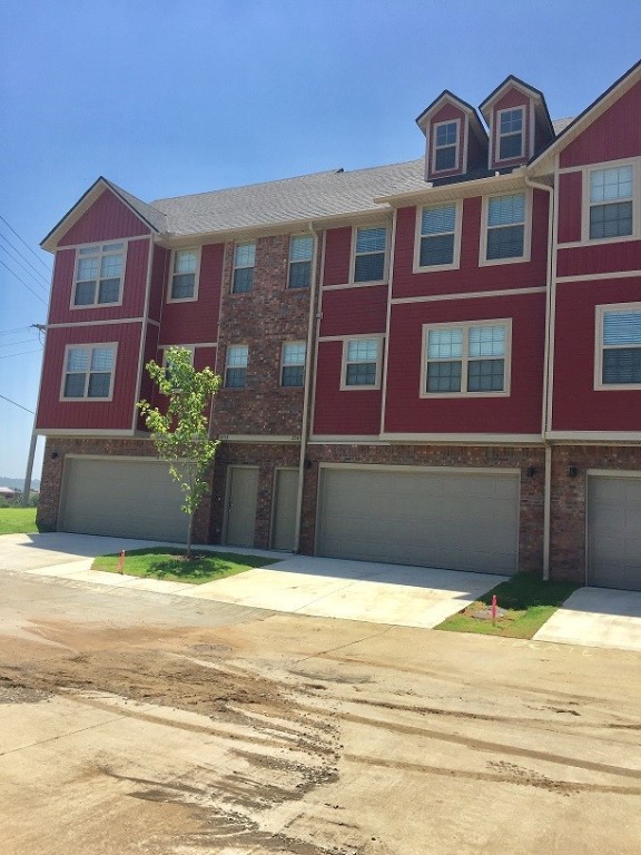 Stylish, modern townhouse near I-49, the University of Arkansas, Centennial Park, shopping, and minutes from all NWA has to offer. Ground floor entry to a 2 car garage; second floor is open concept with living room, dining area, half bath, and kitchen. Kitchen has all stainless appliances, pantry, and granite counters. Walk out wood deck off kitchen/living area. Third floor has 2 bedrooms, 2 bathrooms and laundry. Washer & dryer included. Great floor plan for entertaining. Photos of like unit. Available late July/early August.
