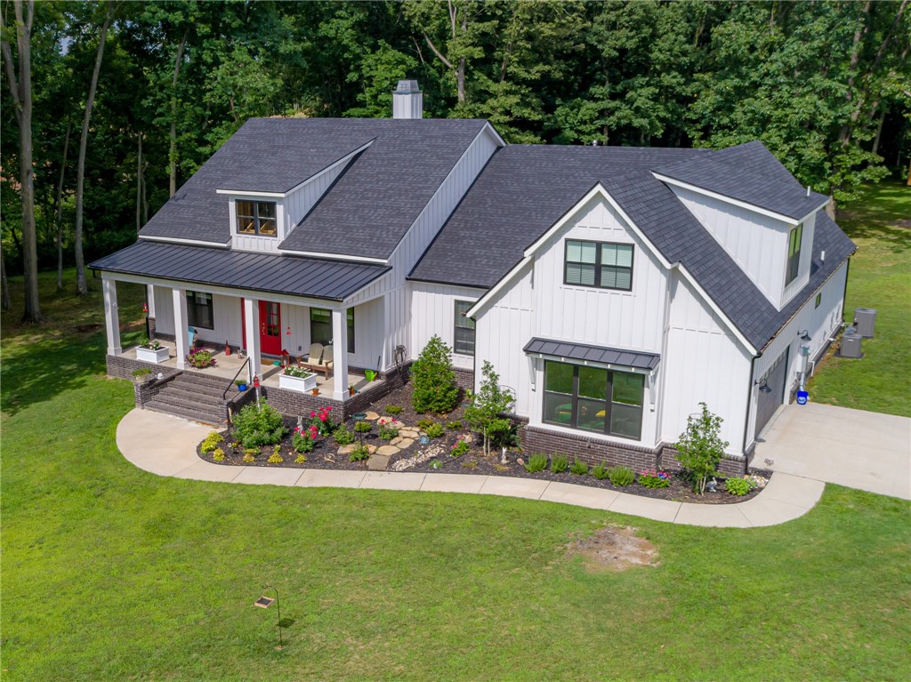 Country living on 5 acres that is still close to the city, airport and Walmart Corporate Offices. This modern farmhouse with thoughtful finishes throughout will take your breath away! Gorgeous barrel ceilings welcome you into this one of a kind space. Main level includes Chef’s kitchen with Fisher & Paykel appliances away from bedrooms to minimize noise. Master suite is complete with workout room/office and  oversize soaker tub/walk in shower with on-demand hot water throughout.  Super large laundry room and master closet connect to master bedroom for convenience.  Upstairs boasts en suite bedroom/media room for visitors to have privacy. Other features include spray foam attic insulation to lower utility bills, extra-large and private back vaulted ceiling patio that can be easily tiled and screened in if needed, wired for security and sound system inside and out. Top of the line storage garage in back of property to help minimize garage clutter. Still have plenty of room to put in pool or shop building.