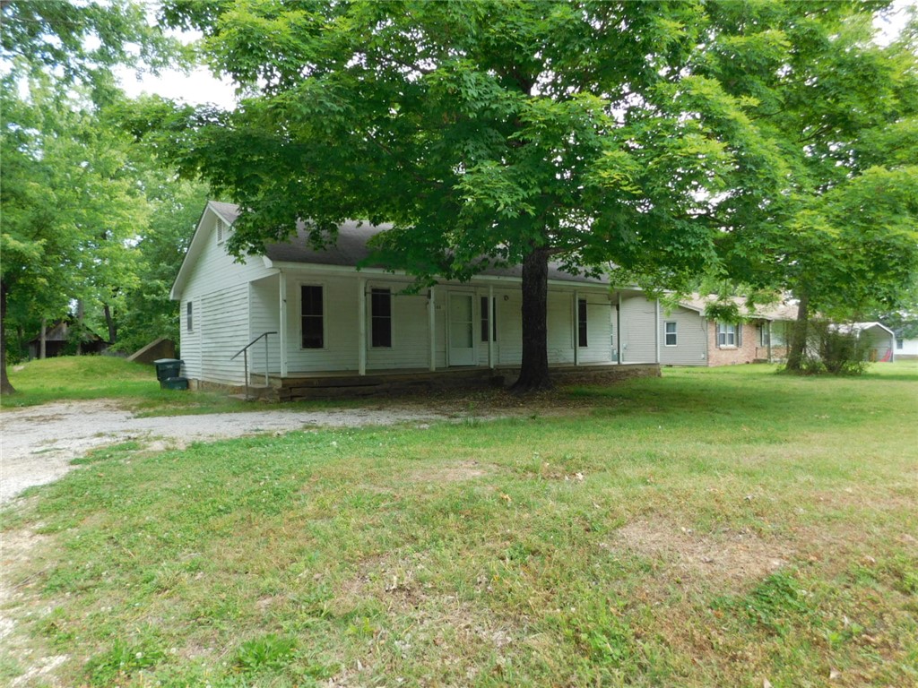 Opportunity knocks with this one! This 115-year-old home has been tenant occupied for years. It is livable but needs a lot of upgrades (currently 2 gas space heaters and no A/C). Living room has been used as a bedroom. However, the lot is a FULL 1.38 acres right on the highway. It could readily accommodate a number of residential configurations - developers take note! All utilities are on site. Be advised that any residence utilized going forward will need to be connected to city sewer (the septic system is worthless and will be abandoned). There is also a cell tower easement crossing the property.