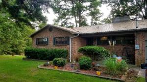 Enjoy watching the wildlife while sitting on your back deck over your large 2 acre yard.  This FOUR bedroom, 2 story house that sits out side of city limits, but only a few miles from town is perfect for you! This house is like having 2 houses! Upstairs include the kitchen, dining, living room with a large rock fireplace, a screened in porch and 2 bedrooms with a full bath. Downstairs include laundry, another living room with another rock fireplace, 2 bedrooms and a full bath. Downstairs also has access to under the house basement that is perfect for taking cover in severe weather.  The metal roof is under 2 years old. New paint throughout. Too much to mention. Call for your showing today!
