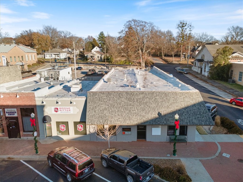 $285,000 in recent upgrades incl new TPO roof, shingles, HVAC units, & exterior paint! Amazing opportunity to own TWO buildings in downtown Siloam Springs! Current monthly rent for 101/103 is $4,390 !  101 N Broadway sits on a corner lot with parking on the side, in the front, and in back, incl private parking areas in the back. Building features multiple office spaces (12), a conference room, kitchen, 2 restrooms, and additional storage rooms. Entryway features secure keypad entrance for tenants/owners. Has been very well maintained. Recently used as office spaces and recording studio. This building features 4400 sq ft, and has a front entrance and back door entrance with a security light out back exit. Building at 103 N Broadway is currently tenant leased as an insurance office.  (No inside pics are shown but has had some recent updating and is very nice-Please don't disturb w/o a showing appt) -Brand new roofs 2025- TPO-brand new heat/air unit 2025. new paint 2025