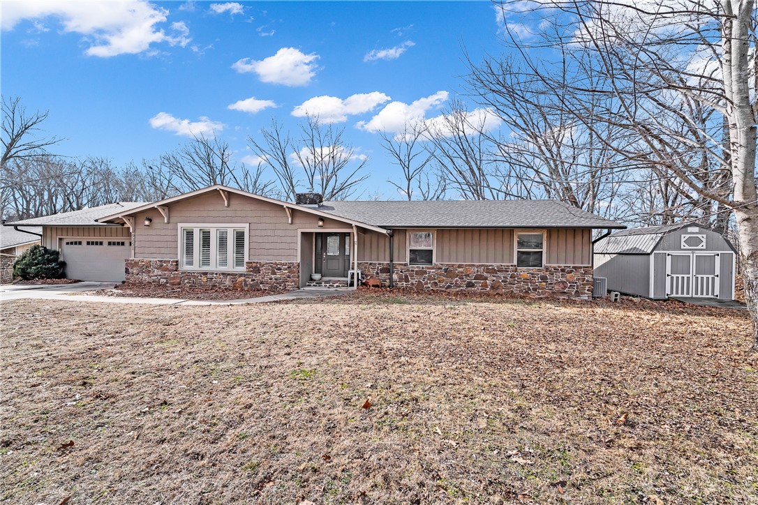 Welcome to 9251 Grimes Drive, where lake life meets comfort on over a third of an acre. This 4-bed, 3-bath ranch offers 3,166 square feet across two levels. The main floor features an open layout with a spacious living room, formal dining, and eat-in kitchen with quartz counters. The finished walk-out basement includes a generous game room and wet bar, perfect for entertaining. Enjoy wood and tile flooring throughout. The wooded lot provides privacy and scenic views, with a covered patio and deck for outdoor relaxation. Just minutes from Prairie Creek Marina and Beaver Lake, this property offers the perfect blend of recreation and convenience. Enjoy easy access to golfing, boating, fishing, and lake life right at your doorstep, while being less than 5 miles from downtown Rogers with its shopping, dining, and entertainment. Whether you're looking for a weekend retreat or full-time residence, this location combines natural beauty and city convenience in one ideal spot.