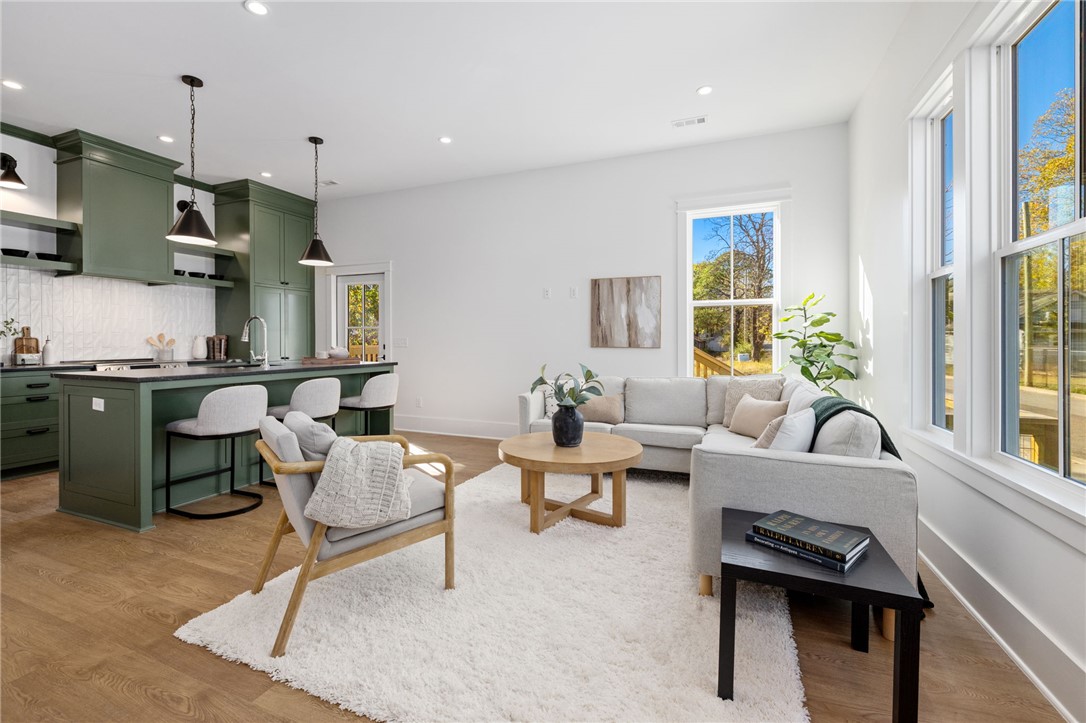 Live beautifully, comfortably, and connected in a thoughtfully designed cottage in the 11th Street Cottages community. Created around both privacy and connection, the neighborhood offers shared green spaces, native gardens, and welcoming front porches that make it easy to enjoy a true sense of community just blocks from the Razorback Greenway and Walker Park. Inside, 10’ ceilings, tall windows, and natural light create an airy, inviting feel. The main level includes a spacious living room, separate kitchen with dining area, custom cabinetry, granite countertops, tile backsplashes, and a private bedroom suite with full bath and walk-in closet. Upstairs, the large primary suite offers an office nook, dressing room/closet, double vanity bath, soaking tub, and Carrara marble. With ENERGY STAR® systems for comfort, efficiency, and healthy indoor air quality, this home offers rare build quality, energy performance, and thoughtful design at a price point under $400K in Fayetteville.