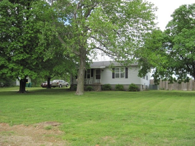 Adorable 2 bedroom 1 bath home in Centerton sets on 1/2 acre. has hardwood floor and a sunroom, fenced yard and detached 1 car garage. Mature trees, country setting.