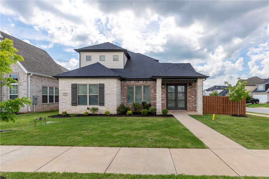 Resort-Style Living in Bentonville’s Coveted Aurora Community. Welcome to 6200 SW Luna Ln, a beautifully crafted 4 bedroom, 3-bathroom home offering 2,460 sqft of living space on a desirable east-facing corner lot. A fully fenced backyard, rear-entry garage, & corner location create exceptional curb appeal & privacy. Inside, soaring vaulted ceilings & abundant natural light enhance the open-concept layout, seamlessly connecting the living, dining, & kitchen areas, perfect for everyday living & entertaining. A bonus flex room offers endless possibilities as a home office, fitness area, or creative retreat. Residents enjoy resort-style amenities including an adults-only pool, children’s pool, clubhouse, pickleball court, playground, & dog park. Ideally located near top-rated Bentonville schools, Walmart’s Home Office, shopping, dining, biking trails, & Downtown Bentonville. Move-in ready & thoughtfully designed, this home offers the perfect blend of comfort, flexibility, convenience, & community.