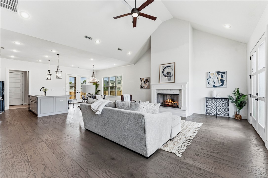 Resort-Style Living in Bentonville’s Coveted Aurora Community. Welcome to 6200 SW Luna Ln, a beautifully crafted 4 bedroom, 3-bathroom home offering 2,460 sqft of living space on a desirable east-facing corner lot. A fully fenced backyard, rear-entry garage, & corner location create exceptional curb appeal & privacy. Inside, soaring vaulted ceilings & abundant natural light enhance the open-concept layout, seamlessly connecting the living, dining, & kitchen areas, perfect for everyday living & entertaining. A bonus flex room offers endless possibilities as a home office, fitness area, or creative retreat. Residents enjoy resort-style amenities including an adults-only pool, children’s pool, clubhouse, pickleball court, playground, & dog park. Ideally located near top-rated Bentonville schools, Walmart’s Home Office, shopping, dining, biking trails, & Downtown Bentonville. Move-in ready & thoughtfully designed, this home offers the perfect blend of comfort, flexibility, convenience, & community.
