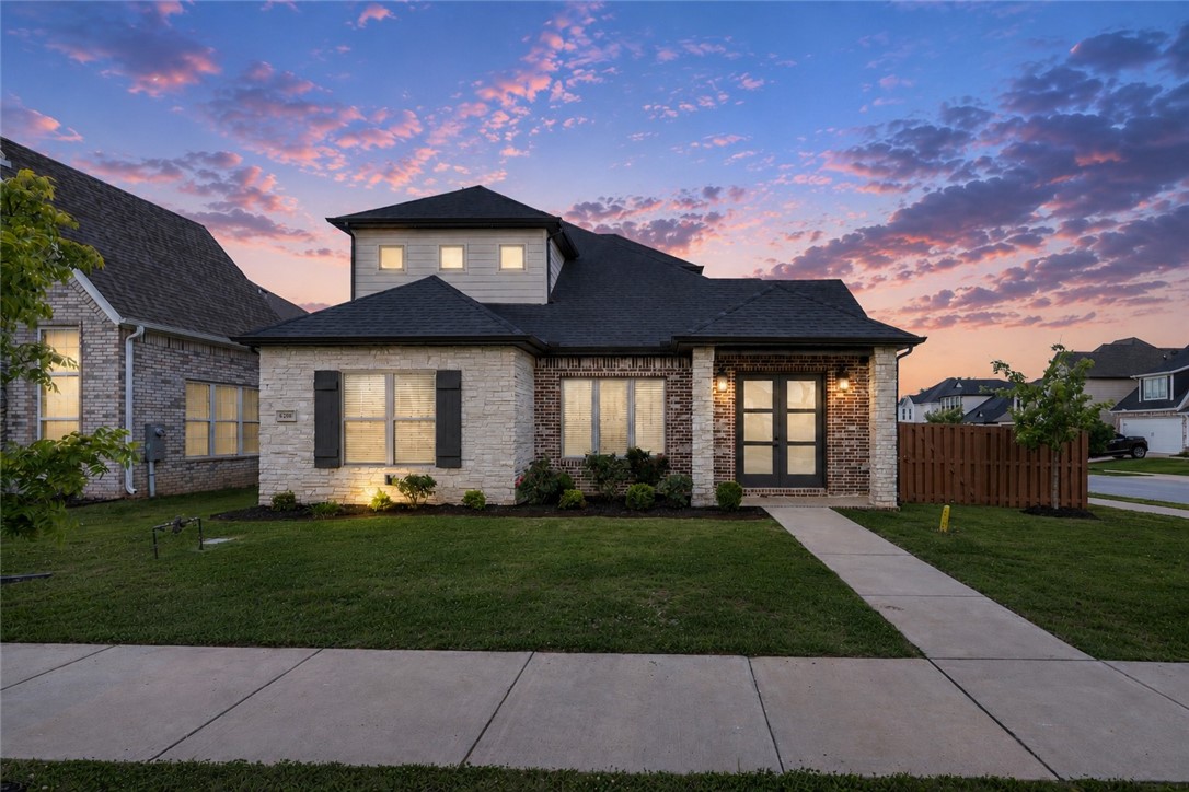 Resort-Style Living in Bentonville’s Coveted Aurora Community. Welcome to 6200 SW Luna Ln, a beautifully crafted 4 bedroom, 3-bathroom home offering 2,460 sqft of living space on a desirable east-facing corner lot. A fully fenced backyard, rear-entry garage, & corner location create exceptional curb appeal & privacy. Inside, soaring vaulted ceilings & abundant natural light enhance the open-concept layout, seamlessly connecting the living, dining, & kitchen areas, perfect for everyday living & entertaining. A bonus flex room offers endless possibilities as a home office, fitness area, or creative retreat. Residents enjoy resort-style amenities including an adults-only pool, children’s pool, clubhouse, pickleball court, playground, & dog park. Ideally located near top-rated Bentonville schools, Walmart’s Home Office, shopping, dining, biking trails, & Downtown Bentonville. Move-in ready & thoughtfully designed, this home offers the perfect blend of comfort, flexibility, convenience, & community.