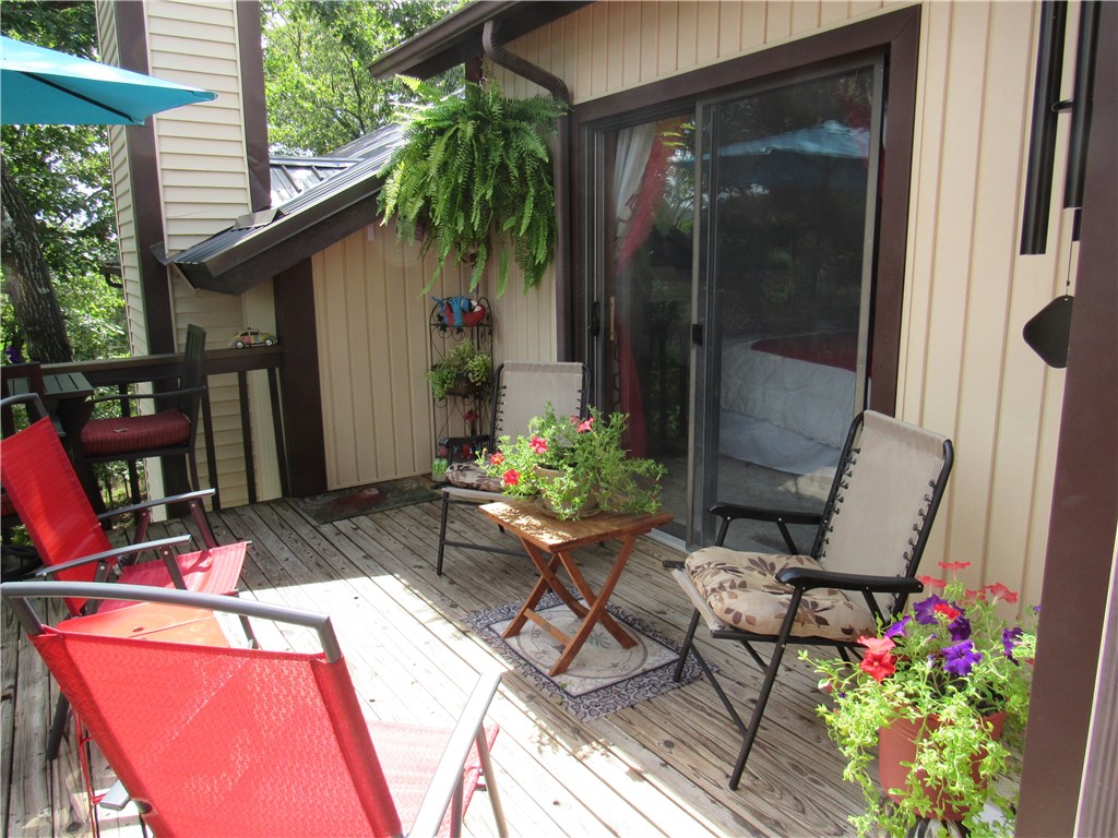 Beautiful newly remodeled one-level condo with new bathroom with two sinks, new floors, new interior paint and brand new pellet stove.  Pristine condition and move-in ready.  Very high ceilings and lots of natural light make this a very desirable unit.  Washer & dryer in unit with lots of interior storage and closets.  Additional storage on front porch and in carport building. Huge entertainment deck off of living room and master bedroom.   Two parking spaces with one a covered carport. New water softener.