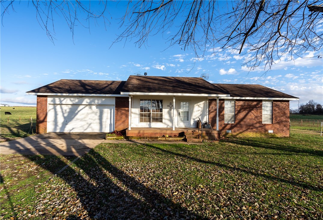 Come take a look and experience the tranquility of nature that surrounds you. Whether you're relaxing on the deck with friends or walking the acreage, you'll love the quiet, peaceful feeling. 2.5 fenced, pasture acres with 2 loafing sheds. Ranch style farmhouse, 3 bedrooms, 2 full baths. Wood laminate flooring in the majority of the home, carpet in 2 bedrooms & tile in the wet areas. 2 car garage with large storage area. Survey available. Rural water, septic, all electric. Round pin panels do not convey. Frost free faucet near road for watering animals. Security system with Brinks thru July 2021, buyer may take over contract if they choose. System owned and to remain with home.