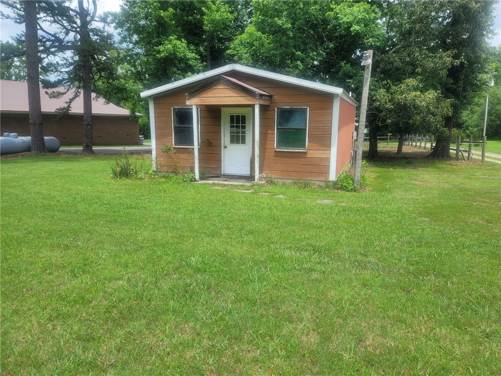 Potential for a good storage shed on a flat .14 (+/-) lot with road frontage. It is hooked up to water, and it will need an electric meter put in but it is wired. There could be multiple uses for this property. Bring your ideas and an offer.