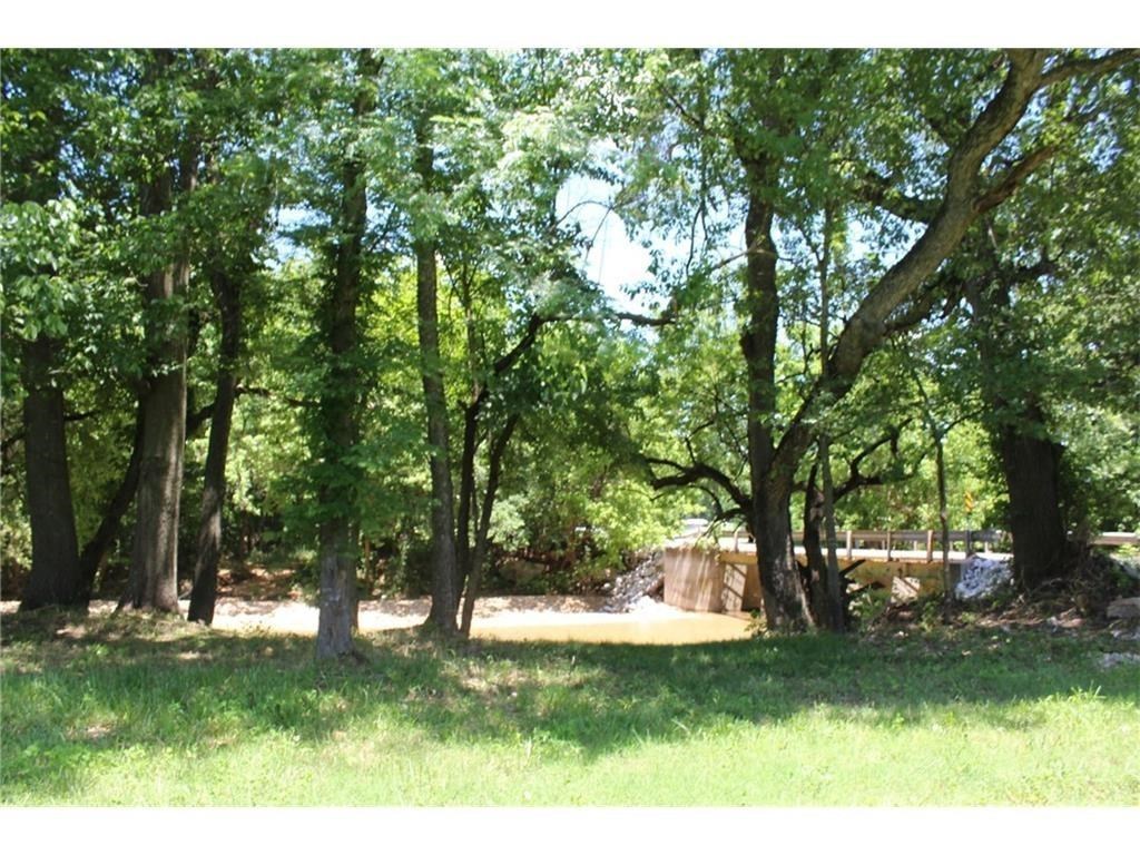 BENTONVILLE SCHOOLS. Park like setting, convenient to everywhere in NWA and Beautiful Spring Creek in you back yard. Estate size lot w/strict architectural covenants. Come enjoy country living at its best in this charming neighborhood. Engineering plan for all homes to be built up & out of flood plain. Flood Insurance not required