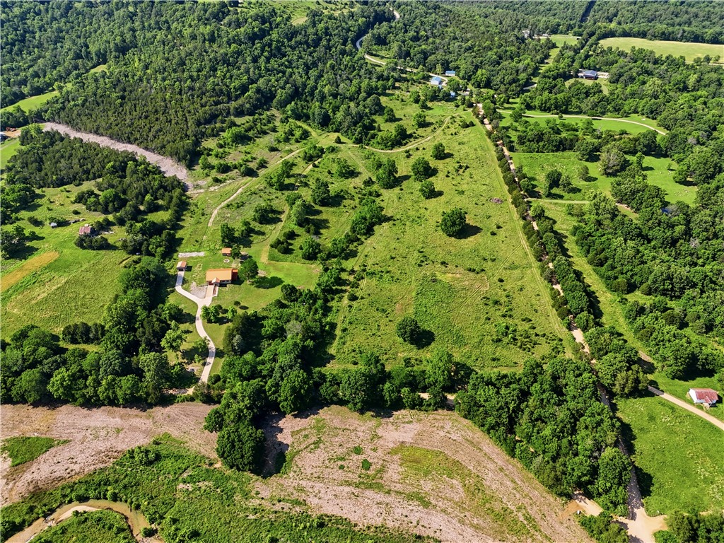Ideally positioned directly across from the Kings River, this 6.60-acre tract offers an exceptional opportunity for a custom build, hobby farm, or rural retreat in a premier Kings River location. Situated across from Kings River public access and the Arkansas Game & Fish Wildlife Management Area at Rockhouse, the property combines usable land with outstanding recreational opportunities. Gently rolling pasture provides an ideal building site with ample space for a residence, barn, shop, or hobby farm, all within a scenic Ozark setting known for its natural beauty and outdoor recreation. Additional adjoining and nearby acreage is available separately for additional acreage. This is part of a Total Combined MLS listing 1349341.