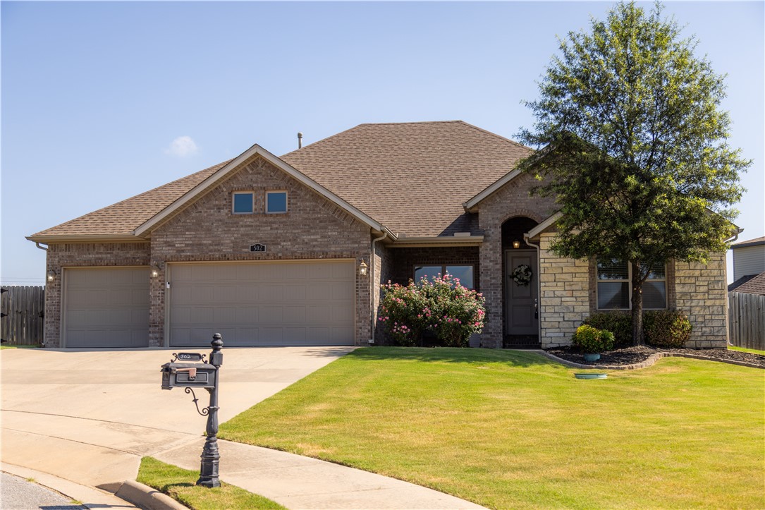 Move-in ready home in the wonderful Brentwood subdivision of Cave Springs! Enjoy neighborhood amenities including a pool and playground, plus a convenient location just off Hwy 264 with easy access to parks and more. Situated on a corner cul-de-sac lot, this home features a large privacy-fenced backyard partially bordering POA property, creating a spacious feel. Inside, the open floor plan offers a vaulted living room with wood beams and gas log fireplace, formal dining, and a kitchen with granite countertops, large island, and breakfast nook. The primary suite includes a vaulted ceiling, walk-in closet, jetted tub, walk-in shower, and dual vanity. A vaulted front bedroom is ideal as an office or guest room with easy access to a full bathroom, while two additional bedrooms share a connecting full bath. Complete with a covered front porch, welcoming entry, covered back patio, central vacuum, 3-car garage, alcove with shiplap accent wall plus hooks, and attractive brick-and-rock exterior with established landscaping.