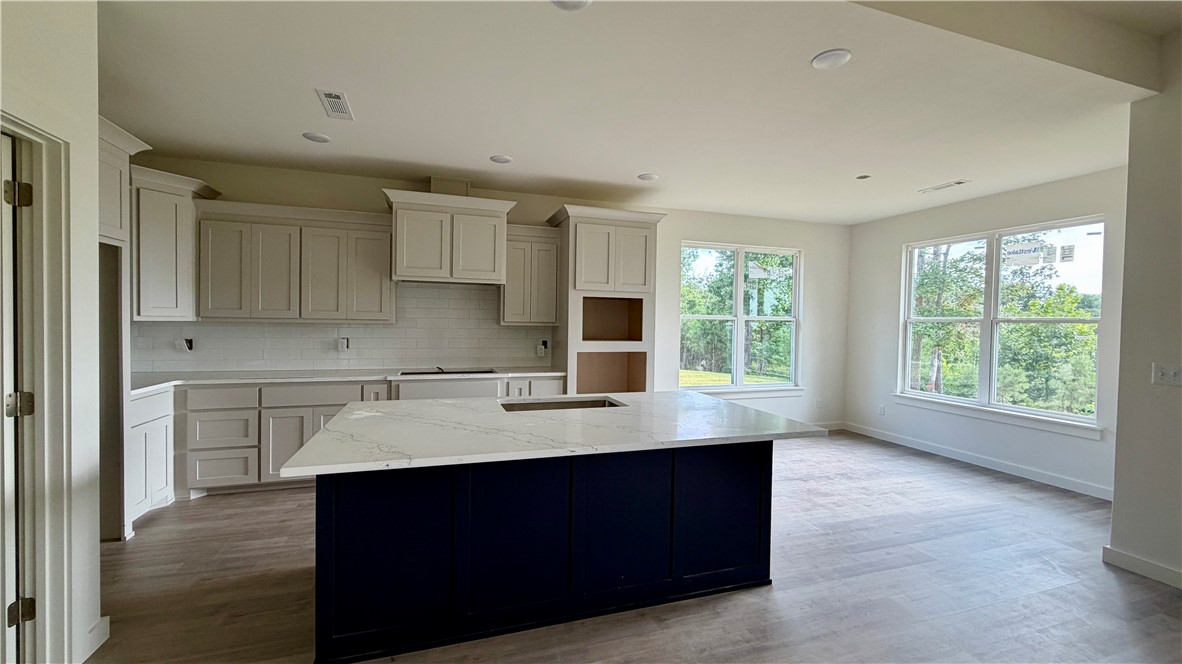 If you’re looking for a place to start making memories that’ll last a lifetime, this is a great place to land! Bonus points for being a new construction home sitting on 5 beautiful acres & of course, there’s already a shop.  If you aren’t calling your lender & have a time set to see this one, you better get busy so you don’t miss out. Inside you’ll find 4 bedrooms & 2.5 bathrooms, a large open living area with lots of windows to see the gorgeous views. You will have room to bake dozens of cookies in the oversized kitchen, featuring an island for extra work space, room for stools to sit around plus a dining area. The home has LVP flooring for beauty and durability, Quartz counters to showcase your exceptional space & stainless appliances to pull it altogether. Inviting, neutral paint throughout for any style you choose to decorate your new space. This dream is located near Beaver Lake & just down from Hobbs State park. A great location for any outdoors enthusiast, yet not far to the developing downtown of Rogers.