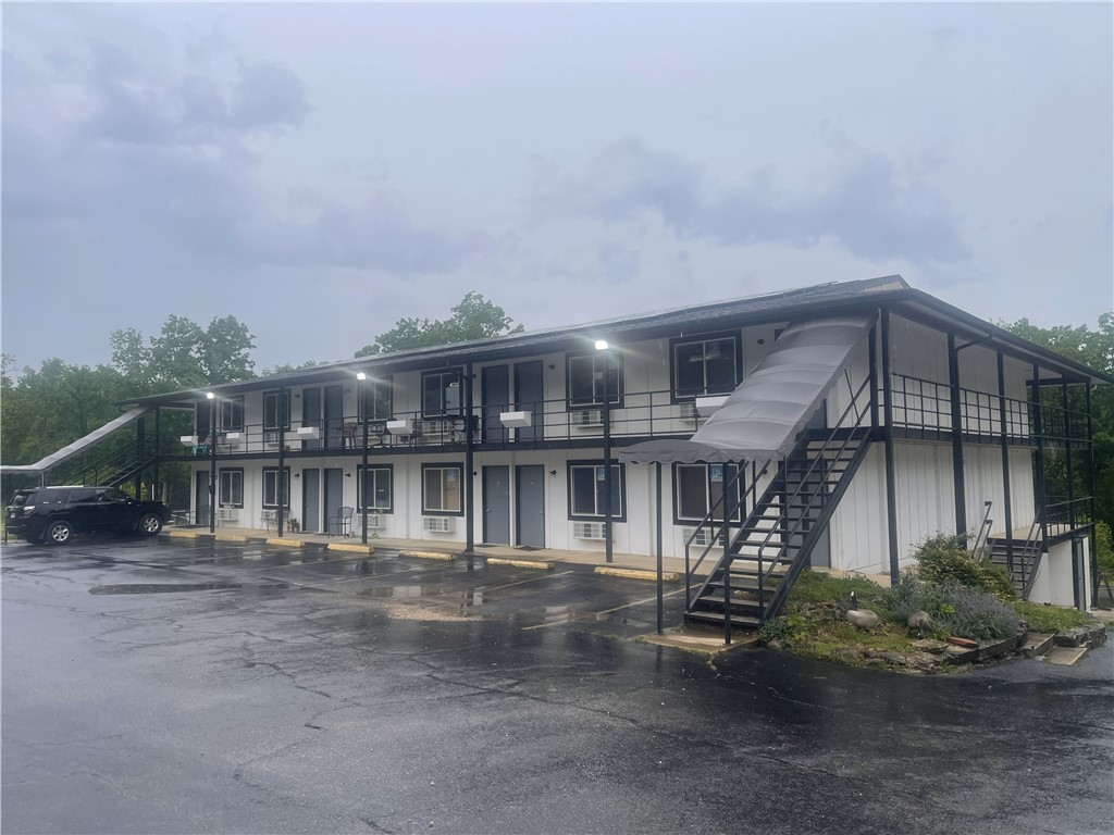 Exceptional Investment Opportunity in Holiday Island, AR
Unlock the potential of this commercial property offering multiple income streams. Located in a growing resort community, it includes two major features:
1. Hotel-to-Multifamily Conversion: A 10,500 sq.ft. building, originally a 30-room hotel, is being transformed into 24 studio and 1-bedroom units, with 11 already completed and rented. Ideal for short or long-term rental income.
2. Turnkey Restaurant & Bar: A 4,338 sq.ft. fully equipped restaurant with a commercial kitchen, dining area, and bar. It includes an 832 sq.ft. outdoor deck for events or expanded seating.
Above the restaurant is a 2-bedroom, 1-bath apartment for owner use or additional rental income. Both buildings are on a single tax parcel, simplifying management. This property offers incredible versatility and upside in a thriving destination.