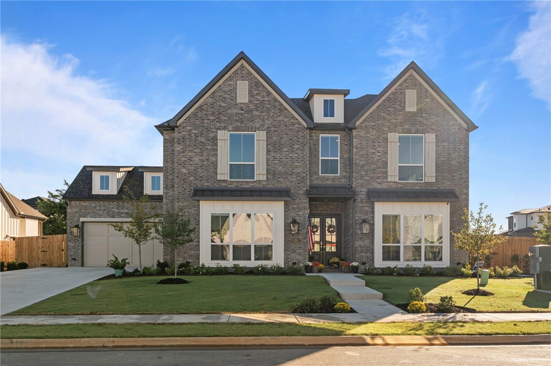 A 2025 Buffington Homes, Hamilton plan! Ask about our preferred lender incentives! A stunning 4-bed, 5-bath + OFFICE + BONUS in Bentonville school district! Enter through beautiful double doors into a spacious, open-concept layout with soaring 12-ft ceilings & abundant natural light. The living room boasts a striking indoor gas fireplace with a single exposed beam mantle & stone detailing. The chef-inspired kitchen features 3 cm quartz countertops, custom cabinets to the ceiling, & luxurious GE Cafe appliances, while an extended white oak island provides extra storage on back side & prep space. Relax in the luxurious Primary Retreat, complete with a soaking tub, large shower, & spacious walk-in closet. Upstairs, find a game room & three bedrooms, two full baths, & custom tile upgrades in all bathrooms. Enjoy outdoor living on the vaulted-ceiling patio with an outdoor gas fireplace. The garage is insulated, has an epoxy floor, & includes a 240V outlet. Storage shed to convey.