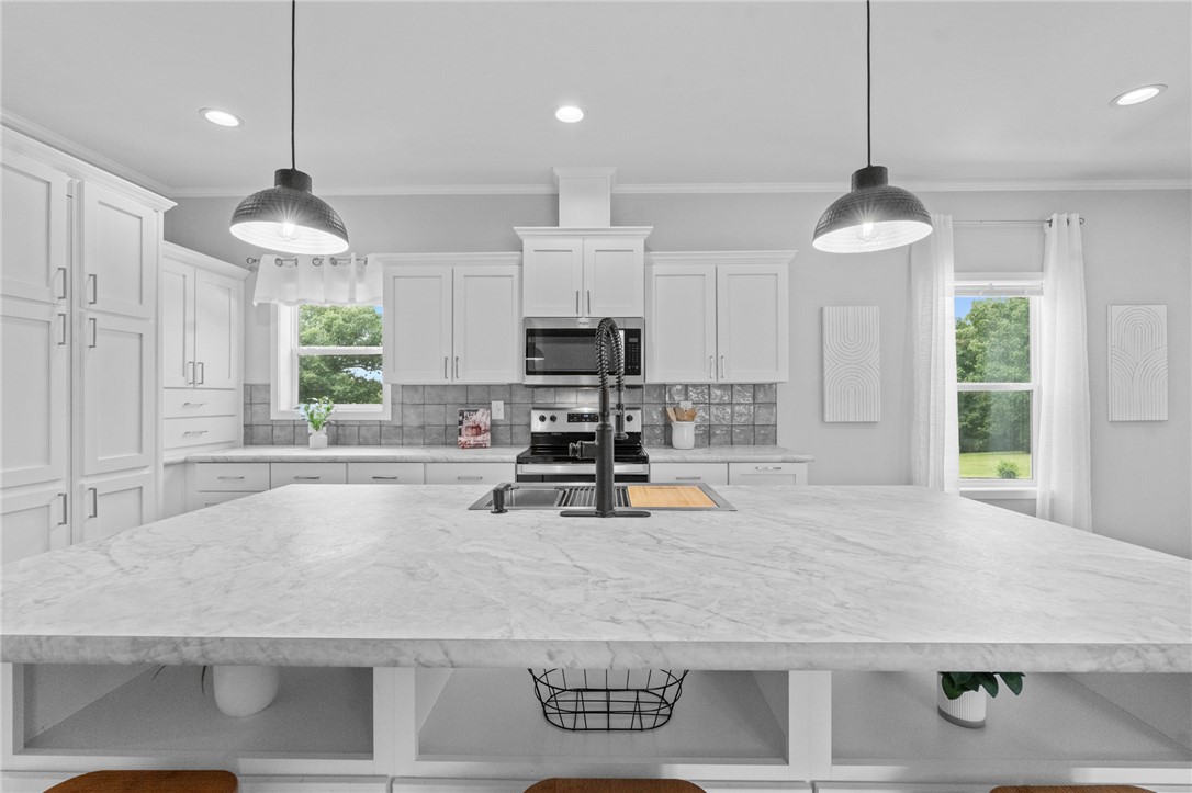 Luxury finishes, park-like setting & outdoor living! Exceptional 3BR/2BA + office  w/builder-quality upgrades. 15 min from Cricket Creek Marina on Table Rock Lake. Bright open 1,586sf plan features LVP flooring, crown molding, recessed lighting, modern linear fireplace & designer kitchen w/large island, HIDDEN pantry, white shaker cabinets, SS appliances & dining. Primary suite offers double vanity, oversized tiled walk-in shower w/glass door & 2-sided walk-in closet w/window & bench. Exterior stands out w/wood accent details, upgraded siding, fabulous oversized covered front porch & covered back porch w/recessed lighting, TV hookups & cultured stone floor. Professionally landscaped setting w/open lawn, views of mature trees, gravel drive, RV/boat parking, well, septic, fiber internet, propane heat & high-value insulation upgrades. Modular w/added porches, canned lights, stone, premium flooring, French drain & WOW landscaping. Approx. 2 acres to be surveyed from larger tract prior to closing. No restrictions.