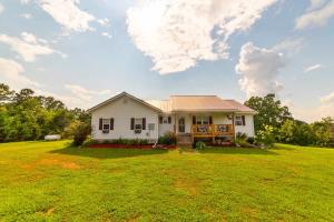 Private setting located at the end of the road on approx 9.10 acres. This 4BR, 3BA has a fireplace, and large composition deck on the back.  Also covered composition porch on front of home. The basement is plumped for a mini kitchen and has a family room, craft room, garage and more. It could be used as a separate living quarter. Built-in generator, 28 x 40 workshop with electric and concrete slab floor & a 20 x 40 raised garden.