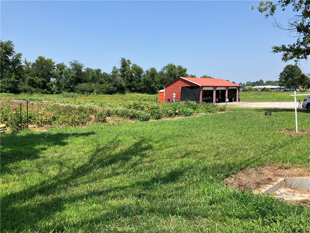Excellent development opportunity in the heart of Siloam Springs! This 4.98-acre +/- parcel is ideally located just off Highway 412 on Kenwood Street. The property is currently being used to grow fresh produce, with the on-site shed/building (36' by 24'), which is wired for electricity, serving as the retail location for produce sales.  Zoned as Planned Development (P-D), the property offers a wide variety of potential development opportunities. An existing survey is available. With easy access, excellent visibility, strong traffic exposure, and flexible zoning, this versatile property is well suited for a super development opportunity!
