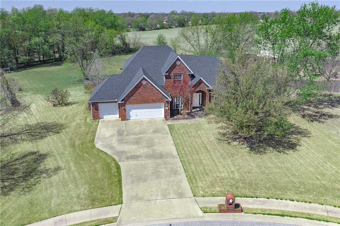 Welcome to 505 Elk Dr in Elm Springs — a beautifully maintained 4-bedroom, 2.5-bath traditional home nestled on 1.11 acres in the quiet, established Oak Ridge Estates. With 2,875 sq ft of thoughtfully designed living space, this home features the primary suite and a private office on the main level, while three additional bedrooms and a full bath round out the upper floor. The stunning double-sided fireplace connects the kitchen and family room, creating a warm, inviting heart of the home. Brand new kitchen appliances, a new roof and gutters, and a new 5-ton HVAC- with new ductwork mean the big-ticket items are already done. A 3-car garage, granite counters, wet bar, and generous storage complete the package. Situated on a cul-de-sac with one of the largest lots in the neighborhood, you're just minutes from Lake Elmdale and I-49. This one checks every box — space, updates, location, and value at $630,000.