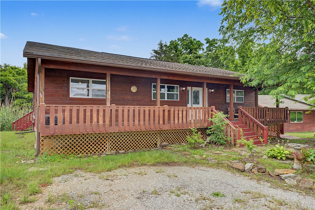 Live comfortably on this 5.38-acre property while enjoying a rare setup for both personal use and business potential. The 3-bed, 2-bath home offers 1,680 square feet with an open layout, a large wrap-around deck, a handicap-accessible ramp, and a 400-square-foot covered front porch perfect for unwinding after a long day. Rest assured as it comes with a NEW HVAC System, NEW Range and NEW LVP Flooring. 

Just steps away sits a 2,640-square-foot commercial building with endless possibilities. Whether you need space for a vintage car or motorcycle collection, a workshop, storage, or a new business venture, the options are wide open. 

Walk your wooded acreage, run your business next door, or rent out the home for extra income. Opportunities like this—especially this close to the lake—don’t come around often.
