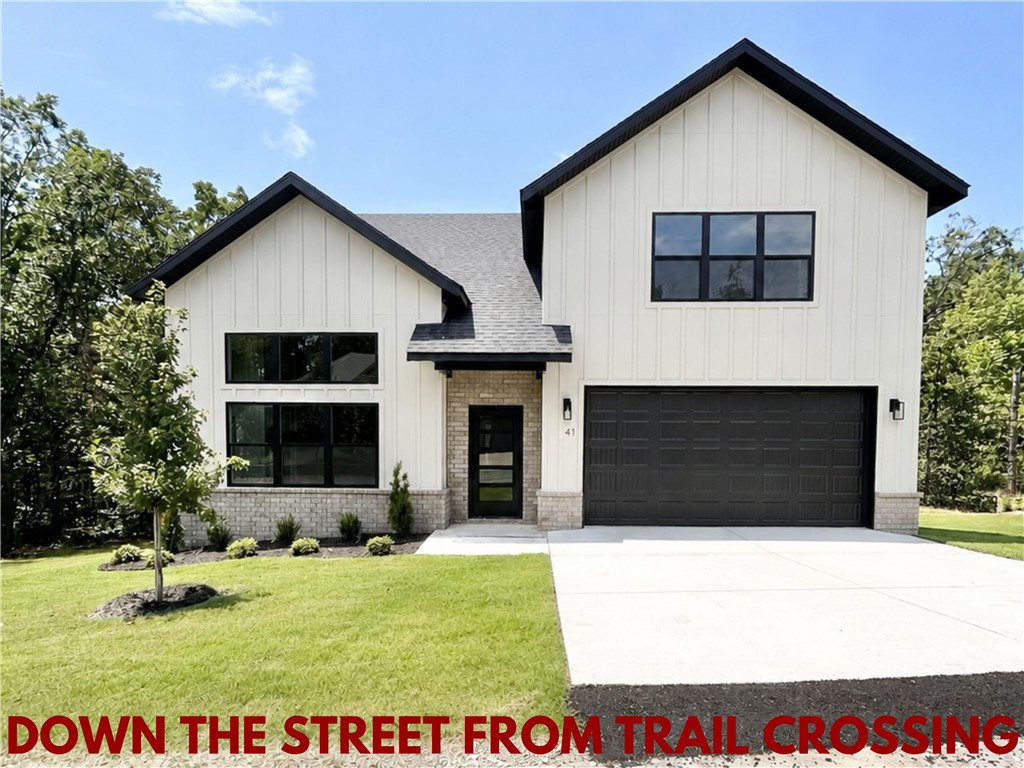 New construction home on a large .31-acre wooded lot! Just down the street from the Taylor Homestead Trail Crossing! Step into a bright and airy interior featuring tall ceilings and a striking 2-story fireplace. The kitchen boasts custom cabinets, a gas range, and 3 cm quartz countertops. The primary bath features a luxurious soaking tub and a walk-in tile shower. Enjoy abundant natural light throughout, and entertain on the spacious deck overlooking the serene landscape. Custom finishes throughout. Bentonville schools! As an added bonus, receive $5,000 towards buyer's closing costs when working with the builder’s preferred local lender! Schedule your showing today!