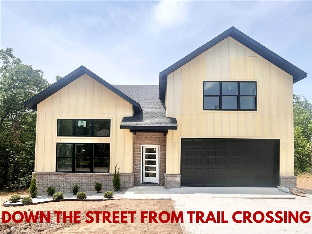 New construction home on a large .31-acre wooded lot! Just down the street from the Taylor Homestead Trail Crossing! Step into a bright and airy interior featuring tall ceilings and a striking 2-story fireplace. The kitchen boasts custom cabinets, a gas range, and 3 cm quartz countertops. The primary bath features a luxurious soaking tub and a walk-in tile shower. Enjoy abundant natural light throughout, and entertain on the spacious deck overlooking the serene landscape. Custom finishes throughout. Bentonville schools! As an added bonus, receive $5,000 towards buyer's closing costs when working with the builder’s preferred local lender! Schedule your showing today!