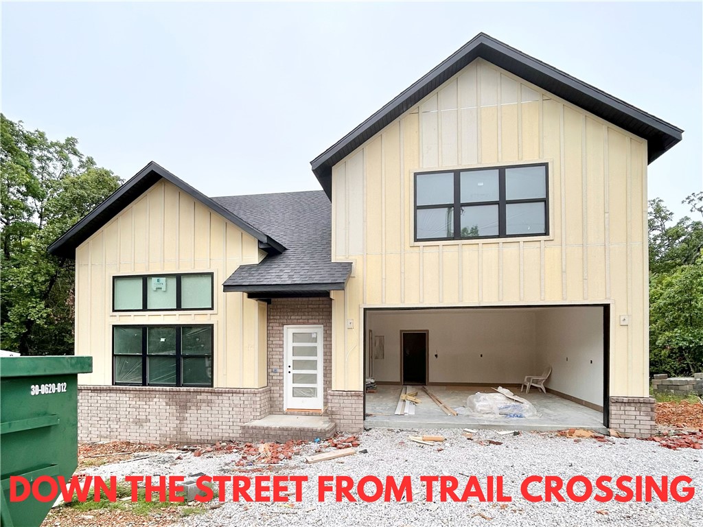 New construction home on a large .31-acre wooded lot! Just down the street from the Taylor Homestead Trail Crossing! Step into a bright and airy interior featuring tall ceilings and a striking 2-story fireplace. The kitchen boasts custom cabinets, a gas range, and 3 cm quartz countertops. The primary bath features a luxurious soaking tub and a walk-in tile shower. Enjoy abundant natural light throughout, and entertain on the spacious deck overlooking the serene landscape. Custom finishes throughout. Bentonville schools! As an added bonus, receive $5,000 towards buyer's closing costs when working with the builder’s preferred local lender! Schedule your showing today!