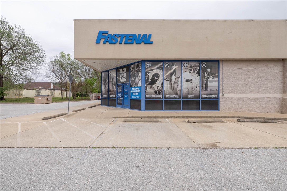 Major Road Frontage (2022 traffic count = 14,000 daily), Near Trails, Neighborhood  (Near Biking, Paved, Walking Trails).  The building contains approx. 6,790 sf, with 12' high ceilings and is clear span throughout. The building is a "blank slate" and can re-purposed with minimal interior demolition. 33 on-site parking spaces. Approx 1/4 acre park-like setting behind the building. Great location in rapidly growing SoFay (south Fayetteville). Across the street is the South Yard project, consisting of 128 apt units plus retail, food, & beverage, & other businesses. Adjacent to the sw are the Varsity House and Grove apartments, consisting of 224 units. Immediately to the east and north are hundreds of relatively new attached and detached housing units. Downtown Fayetteville, Fay High Sch. and the Univ of Arkansas are all just a short drive away. 1/2 block from the Razorback Greenway Trail.