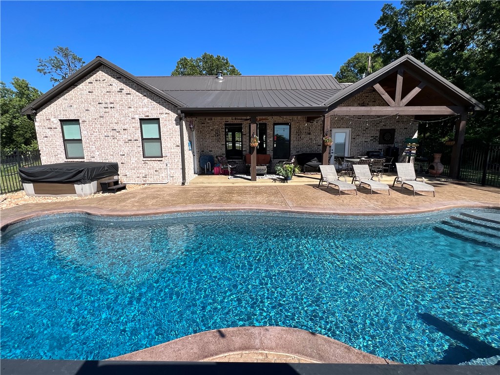 Private Ozark Estate!! 1,808 SQFT home with in-ground pool and 15.83 acres m/l plus 856 SQFT guest house!! End of the road privacy, artisan spring, solar system with battery backup, greenhouse and fenced garden area all with beautiful Ozark Mountain views! The 3BR-2.5 BA main house is all brick, built in 2020, and features cathedral ceilings, granite countertops, a wood stove, tankless hot water heaters, porcelain tile flooring, Jack and Jill bathroom, Anderson windows, spray foam insulation, and a concrete safe room. The salt water pool measures 40x16 and 9 feet at its deep end. The hot tub also conveys. The 1BR-1BA guest house was built in 2019, has CH&A, an office and stained concrete floors. Both homes have metal roofs. The land features approximately 6 acres of fenced pasture, 20x40 barn, storage building, with established pear and peach trees and blueberry bushes. 15 minutes to Harrison and 20 minutes to Branson.