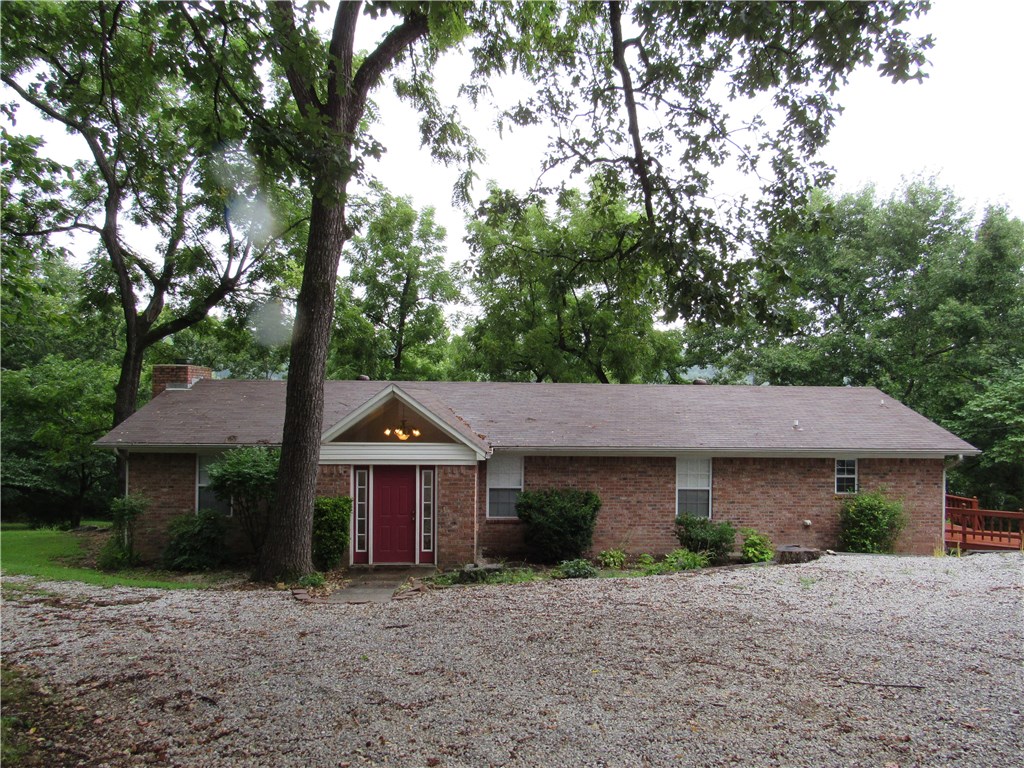 Springdale School District. Close to Hickory Creek Park & Marina.  Large, open LR/DR. Breakfast bar. Lots of storage, built-ins.  French doors from DR and Master BR open to wrap-around deck.  View of lake and surrounding hills.  Oversized detached 2 car garage.  Circle driveway.  Pole barn.  Agent owned.  Owners pay for lawn mowing.