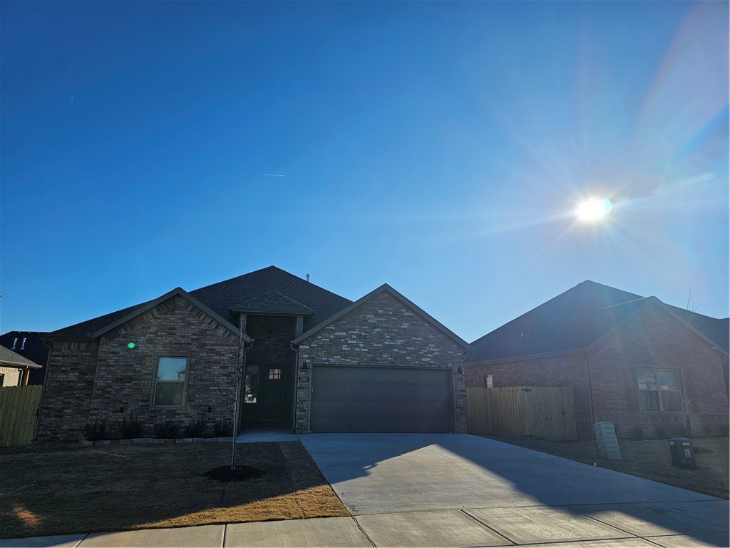 Stunning new construction located just 10 minutes from XNA! You will be in awe the moment you walk through the door and see the gorgeous fireplace and exquisite kitchen with mirrored tile flooring, gas cooktop and walk in pantry. Ready for some relaxation? Come on into the primary suite and submerse yourself in a spa like experience with the fully tiled enormous walk-in shower with soaking tub. More mirrored tile floors really add to the spa-like feel. Both guest bedrooms have generous sized closets. The backyard is fenced for your privacy.