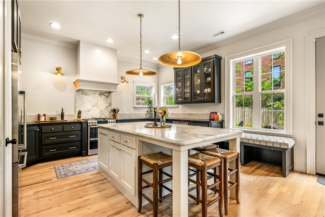 Walk to everything Bentonville is known for -- the Downtown Square and the Walmart home office to Crystal Bridges, The Momentary, 8th Street Market, trails, dining and entertainment -- while enjoying the privacy of a quiet, tucked-away corner in one of downtown’s most desirable neighborhoods. Completely reimagined in 2023, 109 SE G Court offers over 3,000 square feet of refined, move-in-ready living with 4 bedrooms and 4 baths. Thoughtfully redesigned with elevated finishes throughout, the home blends modern style with everyday comfort. The chef’s kitchen features striking Dolomite countertops, updated cabinetry and an open layout designed for entertaining. A spa-inspired primary suite with a luxurious wet room creates a true retreat, while fresh paint, new carpet and designer fixtures bring a polished feel to every space. Rarely does a home offer this level of walkability, privacy and turnkey luxury in the heart of Downtown Bentonville!