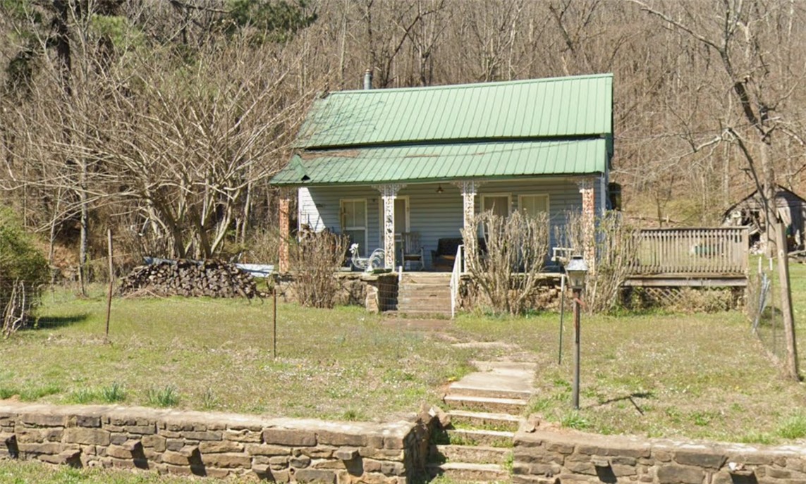 ***Public Auction to be held on-site Friday, May 29th at 10:00 AM. Live and online bidding available.*** 1,612 SF, 4-bedroom, 1-bath home built in 1940 situated on approximately 4 acres. Property features include original hardwood floors, natural stone accents, metal roof, wood-burning stove, and a covered front porch looking out at the mountains. Home includes a cellar with exterior access (needs improvement) and an underground storm shelter. Additional improvements include a detached building approximately 300 SF (+/-) with electric. Former chicken house structure remains, offering salvageable wood and metal materials. Land consists of a mix of open areas and wooded acreage with mature trees and abundant wildlife. Located just over 1 mile from St. Paul, approximately 20 miles to Elkins and Huntsville, and about 30 miles to Fayetteville and White Rock. Reserve auction. Property sold As-Is. Buyers are encouraged to view and/or inspect prior to auction. See website for full terms and conditions.