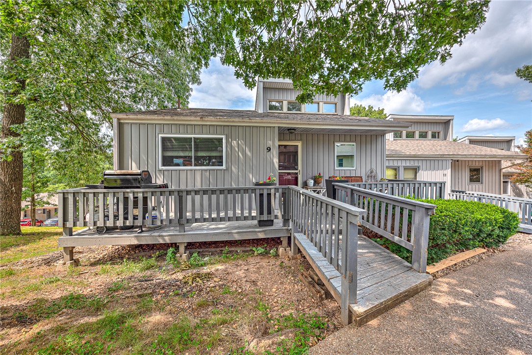 END-UNIT TOWNHOME just minutes from the new OZ Trails Bike Park, Lake Windsor, Tanyard Creek, and miles of scenic hiking and biking trails. Filled with natural light and offering seasonal lake views, this spacious townhome features an open-concept layout with soaring ceilings, hardwood floors, and private upper and lower decks, each accessible from the living area and all 3 bedrooms for seamless indoor-outdoor living. The upper level includes a spacious primary suite with dual walk-in closets and a full bath, along with a kitchen, dining, laundry & living area ideal for everyday living. The lower level offers 2 generously sized bedrooms, a versatile bonus room perfect for a home office, guest space, or fitness room & a large storage closet. Enjoy a low-maintenance lifestyle with exterior maintenance provided by the City of Bella Vista, giving you more time to explore everything this premier location has to offer. This is an exceptional opportunity to enjoy all that Bella Vista has to offer at an outstanding value!