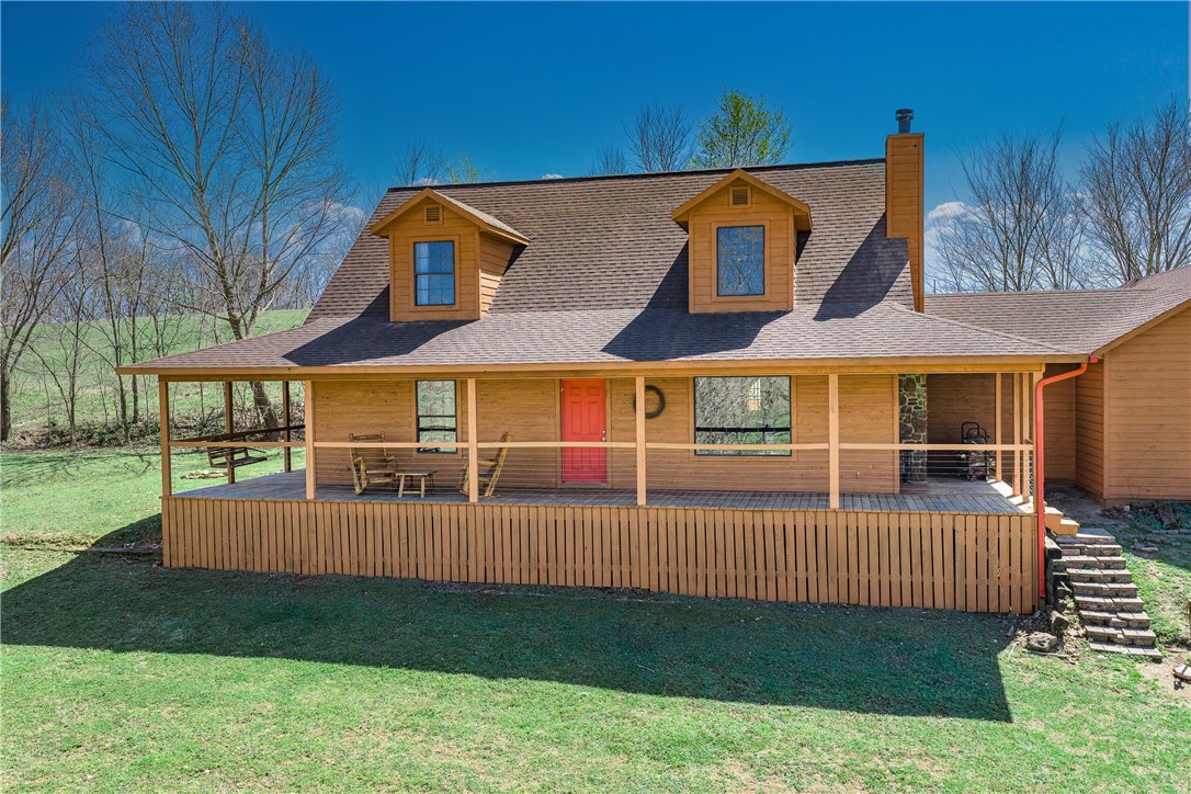 Tucked in the heart of NWA yet worlds away, this country-style retreat is a rare find that checks every box. The en-suite primary bedroom offers a quiet sanctuary, while four bedrooms and three baths across 2,258 square feet give everyone room to spread out. A large wrap-around porch frames breathtaking sunset views — the perfect end to any day.
The grounds are a hobby farmer's dream: fully fenced and cross-fenced with zero covenants, a massive metal shop for every project, and a 3-car garage complete with a large tornado shelter. Explore your own year-round cave spring-fed creek, soak in the color of vibrant Redbud trees, and enjoy rare deeded access to state-owned land to the west.
The kids will claim the heated and cooled treehouse as their year-round kingdom — or reclaim it as your she-shed. Raised garden beds round out this one-of-a-kind property that delivers true country living without sacrificing a central NWA location.
