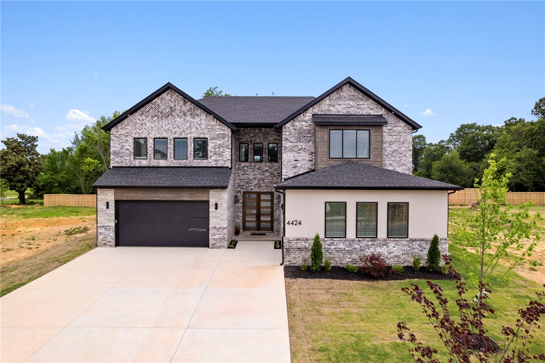 Recent Price drop PLUS, seller will pay $25,000 towards closing costs! Priced to SELL! Welcome to this gorgeous new construction home in Bentonville right across the street from a highly desired elementary school. Fencing recently installed. This contemporary home offers all the space you could desire! Five large bedrooms, Five and half bathrooms, plus a separate office, plus bonus room.  The soaring ceilings in the living area make the home feel grand. Chef inspired custom kitchen open to the living area and large dining room overlooking the back yard. The yard is perfect to install a pool. Make it your own with some vision! Downstairs you have your master bedroom, a guest bedroom, and your private office. Upstairs you have 3 additional bedrooms plus a media room! This subdivision is located outside of Scissortail, Soaring at Scissortail community. Elevated contemporary interior finishes throughout that is sure to WOW you! Schedule your showing today. Located near Pinnacle area, Promenade shopping, & restaurants!