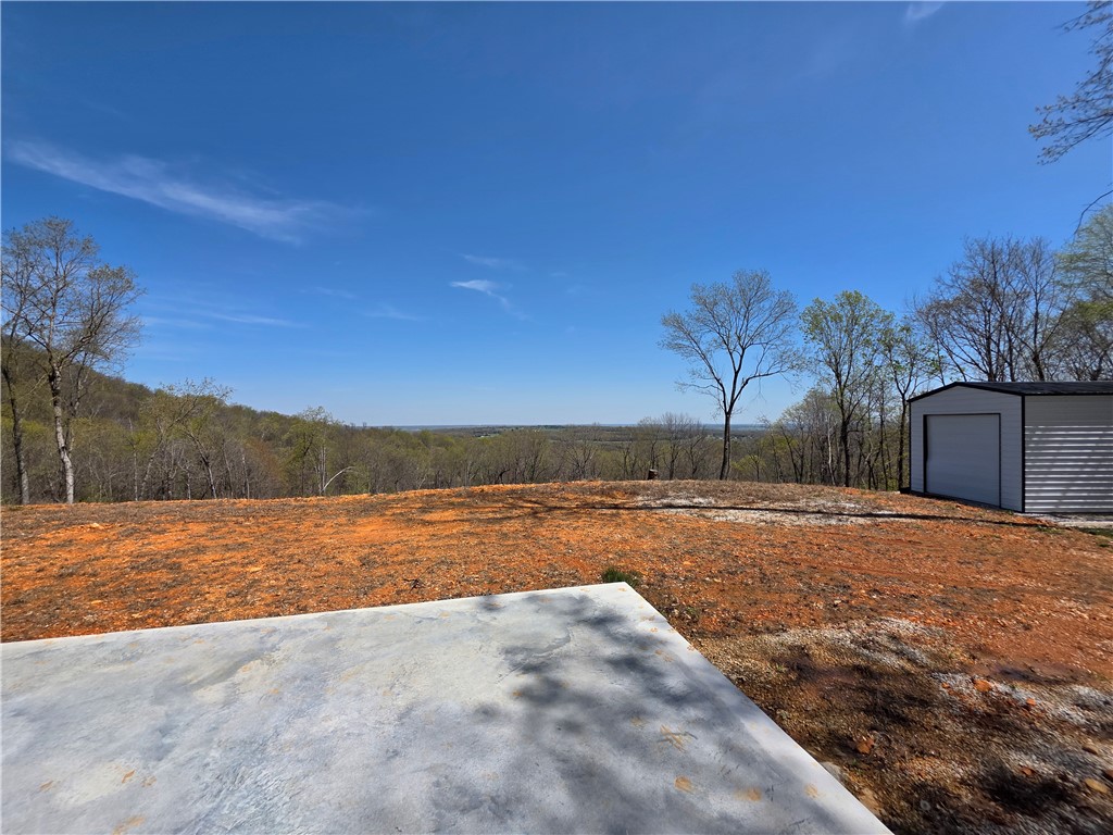7 m/l AC Building Lot with buried electric to site AND a view, located between Harrison and Compton.  If you're looking for an "end of the road seclusion" building lot with a long distance view, this is it!! Located in the Gaither Mtn Estates where there is only one other home built with no remaining lots available besides these 3. These lots come altogether to give you 7.16 acres. A lot of the work has already been done: The driveway was developed using extra deep base and topped with white rock with culverts added where needed, the outstanding view has been cleared along with enough acreage to keep the view clear, a quality poured 18x30 pad with water stubs, a brand new "Legacy" brand 18x30 metal building with (2) 12x12 roll up doors and (1) man door on it's own slab, and buried underground electric to the property. A wet weather creek runs beside the property and you can hear it from the building site. 20 minute drive to the Buffalo National River and only 10 minutes to Harrison for all the shopping needs.
