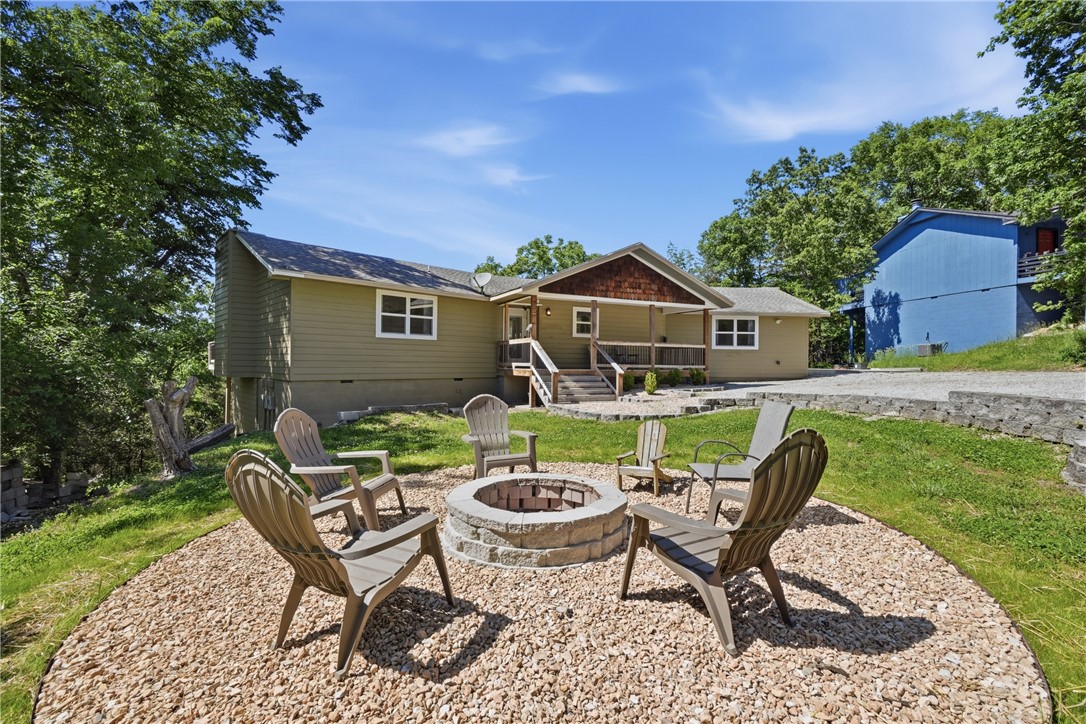 Fully furnished and beautifully remodeled, this 5 bedroom, 2 bath home in the golf and lake community of Holiday Island is the perfect blend of style and comfort. Nearly everything has been replaced, creating a truly move-in ready retreat surrounded by trees with plenty of space to relax and entertain. The open floor plan features a stunning 4x10 granite island, aesthetically pleasing paint colors, updated finishes, and inviting living spaces throughout. Enjoy gorgeous decks and patios that extend the living area outdoors. The spacious primary suite includes a cozy wood-burning fireplace and private access to the deck. Large utility room, abundant parking, and thoughtful updates throughout make this home stand out. HVAC systems and water heaters are only one year old. Located right above the Marina in Holiday Island, near golf, lake access, pools, and all Holiday Island amenities. All furnishings convey at no cost! One of the best nightly rentals in Holiday Island!