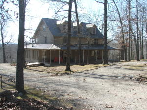 Beautiful 2 story plantation style home on 10 acres within minutes of the famous White River and Bull Shoals Lake! Many upgrades including kitchen cabinets, granite counter tops, jetted tub, etc. and the charm of this home will make you fall in love with it. Two bedrooms could be added in unfinished attic area. Wooded land fronts pavement and affords winter view of the White River. 30x40 Metal double garage/workshop.
