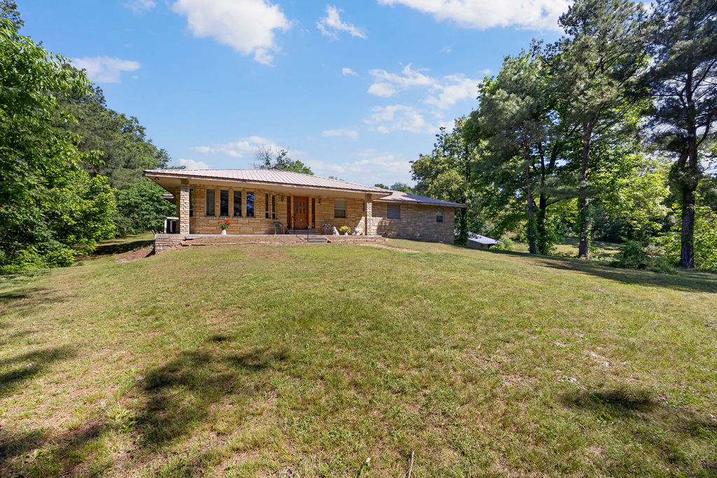 Tucked away in the rolling countryside just outside of Siloam Springs, this ranch-style retreat offers the kind of space, privacy, and versatility that’s becoming harder to find. Situated on 22+/- picturesque acres, this 3 bedroom, 3 bathroom home blends country charm with practical functionality. A durable metal roof adds timeless appeal, while the expansive unfinished 1,100 sq ft walk-out basement offers endless potential for additional living space, a workshop, hobby area, or guest quarters. Outside, the impressive 30x50 pole barn provides approximately 1,500 sq ft of storage for equipment, livestock needs, recreational toys, or future projects. Whether you’re dreaming of a hobby farm, homestead lifestyle, or simply room to roam, this property delivers the freedom and flexibility to make it your own—all while being just a short drive from town conveniences. Being sold as is. Additional 17 acres available for sale.