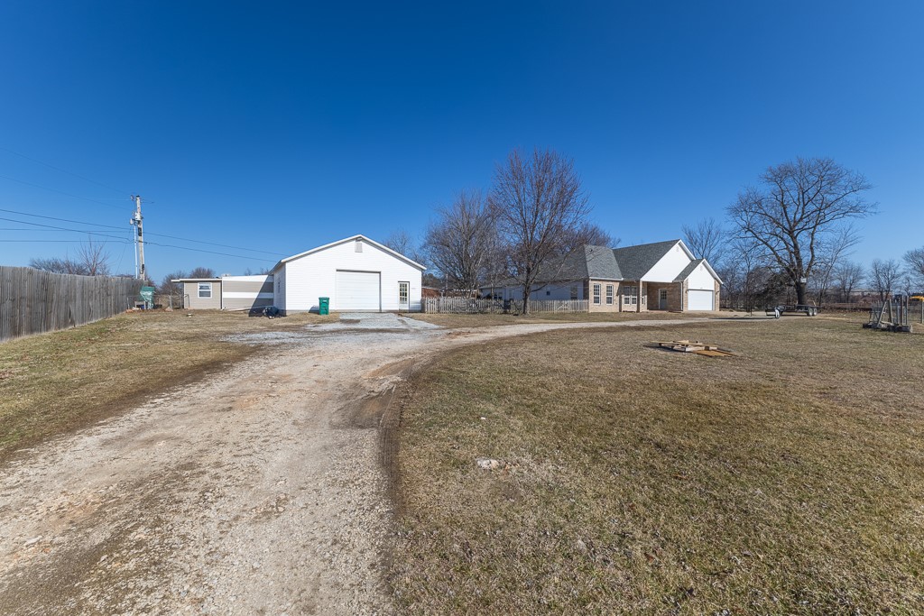 Turnkey property on almost 1 acre off highway 62 on the edge of Farmington that includes single-family home with indoor pool, apartment, and large workshop with combined rental income potential of approximately $3,300–$3,900 per month is available now!  Features include indoor pool, fully fenced yard, private drive, and climate-controlled garage with finished floors. Convenient access to I-49 North and the University of Arkansas enhances rental appeal and long-term value. This opportunity includes 3/2 home, 1/2 apartment, plus x shop with 12ft roll up door currently zoned residential with commercial opportunities. Inside the home you’ll find quartz counters, fresh paint, new roof in 2023,  additional smaller fenced yard in between structures inside of man exterior fence. 
Apartment is all cement flooring, has full kitchen. 1.5 baths, mudroom can be separated, 3 doors to exterior, one entrance to shop. The shop has 12 ft roll up door, plumbed for additional bathroom, and ready to work in.