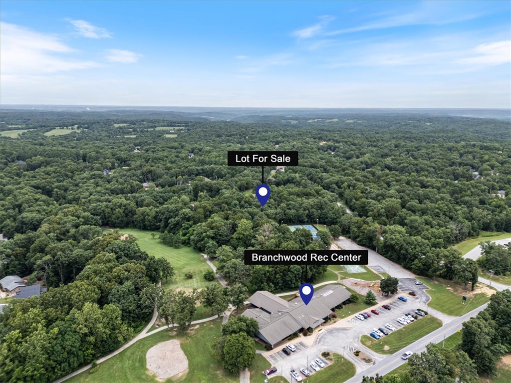 Rare 2.41-acre development opportunity in Bella Vista! This mostly level parcel is zoned R-2, offering excellent potential for regular residential use or townhomes, duplexes, triplexes, and more (buyer to verify with the City of Bella Vista). Located directly north of Branchwood Rec Center, you will enjoy convenient access to golf, trails, parks, recreation, and the amenities that make Bella Vista one of Northwest Arkansas’ fastest-growing communities. With easy access to Hwy 71, I-49, Bentonville, and the Walmart Home Office, this property offers an outstanding opportunity for builders, developers, or investors looking to capitalize on the continued growth of the region. Buyer to independently verify utility availability and zoning details.