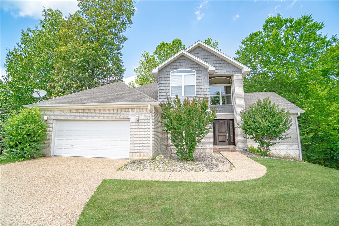 A virtual tour is available upon request. NEAR WALMART HOME OFFICE & I-49! Charming home in a peaceful subdivision at the end of a cul-de-sac with trails & woods nearby. Tons of upgrades within the last 2 years - new hardwood floors, carpet on steps, kitchen flooring, & newly painted interior, and so much more! Entering the home, you’ll notice the unique curved staircase. Enjoy the wooded views from the large windows throughout the home letting in an abundance of natural light. Entering the basement - you’ll find the media room + bedroom making for an awesome space. Kitchen features new backsplash, granite counters, spacious walk-in pantry, & large island. Living room includes a gas log fireplace & formal dining area features a tray ceiling. Retreat to the master suite with the newly renovated shower, large soaking tub, spacious walk-in closet, and cathedral ceiling. Outside won’t disappoint - plenty of seating on the upper and lower wooden deck and one bedroom downstairs having access.