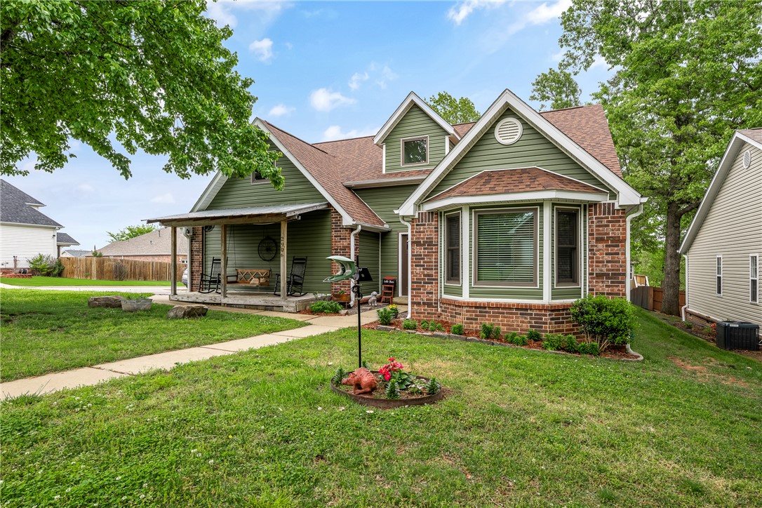 Nestled off A Street, north of Bentonville Square, home offers unbeatable location w/ easy access to walking & biking trails, or quick commute via I-49. Corner lot home features; new roof, siding, Andersen windows, downstairs HVAC system (2024)—giving you peace of mind. Spacious living area w/ vaulted ceilings & cozy fireplace, perfect for relaxing or entertaining. Home features; formal / bright dining space, open kitchen w/ granite countertops & SS appliances. Beautiful woodwork adds character throughout, while primary suite boasts vaulted ceilings, plenty of space, double vanities & walk-in shower. Additional highlights; generously sized bedrooms, LED lighting, welcoming covered front porch for relaxing evenings. Out back, enjoy partially covered deck overlooking stone wall & peach trees—perfect for outdoor living. Additional 179 sq ft of storage / office space not listed in home square footage. Move-in-ready, combines comfort, style, & location! $3,500 buyer concession offered for closing costs or remodeling.