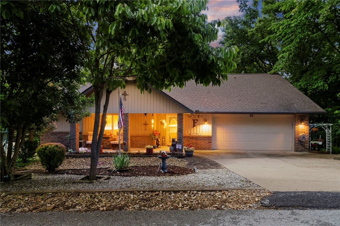 Looking for privacy, flexibility, and room to grow? This move-in-ready Bella Vista retreat includes two parcels totaling .55 acres, including an adjacent buildable lot with perc test and septic design already completed. Fresh paint, updated kitchen and baths, newer roof and HVAC, Pella windows, and luxury vinyl plank flooring throughout mean little left to do but move in. The flexible single-level floor plan offers 3 bedrooms, multiple living spaces, a split-bedroom layout, and an unfinished basement for storage. The trayed-ceiling living room features a fireplace and opens to a bright four-season sunroom overlooking a wooded setting that feels like living in a treehouse. Enjoy the private deck and hot tub that conveys. The additional lot provides lasting privacy, RV/trailer parking potential, and space for a future workshop or detached garage. Near Lake Windsor, golf, trails, and the OZ Bike Park.