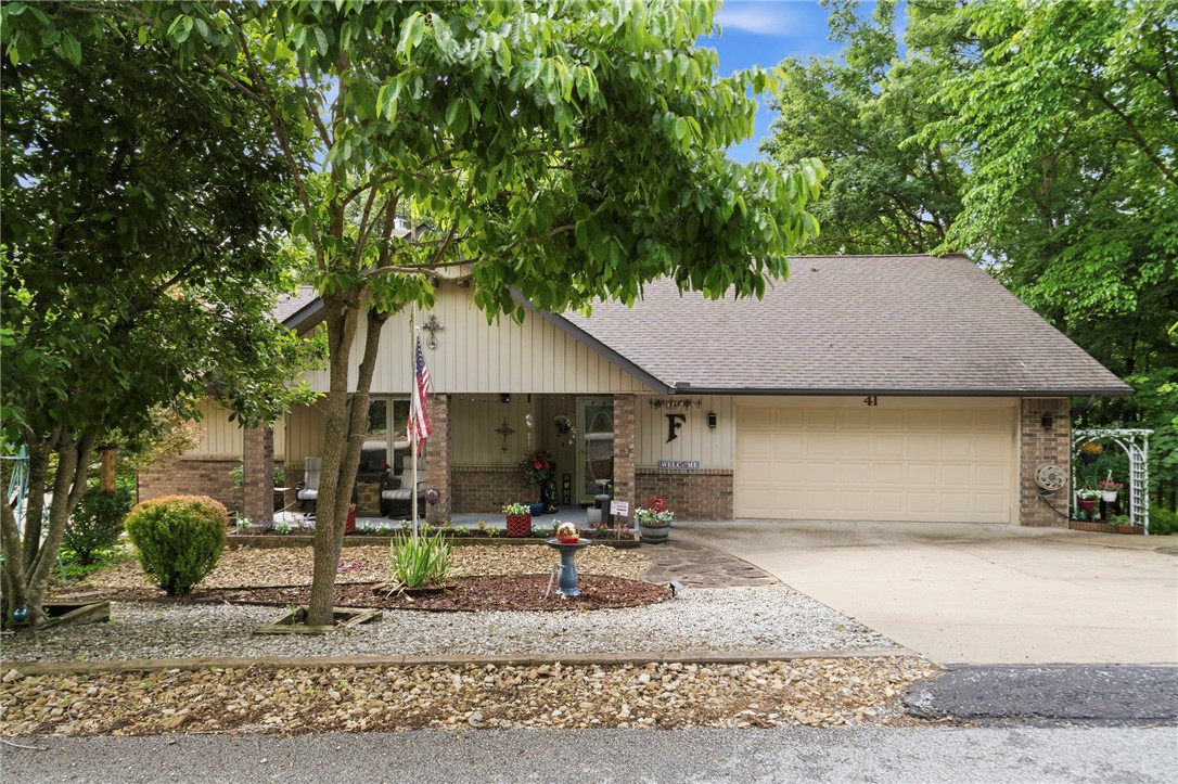 Looking for privacy, flexibility, and room to grow? This move-in-ready Bella Vista retreat includes two parcels totaling .55 acres, including an adjacent buildable lot with perc test and septic design already completed. Fresh paint, updated kitchen and baths, newer roof and HVAC, Pella windows, and luxury vinyl plank flooring throughout mean little left to do but move in. The flexible single-level floor plan offers 3 bedrooms, multiple living spaces, a split-bedroom layout, and an unfinished basement for storage. The trayed-ceiling living room features a fireplace and opens to a bright four-season sunroom overlooking a wooded setting that feels like living in a treehouse. Enjoy the private deck and hot tub that conveys. The additional lot provides lasting privacy, RV/trailer parking potential, and space for a future workshop or detached garage. Near Lake Windsor, golf, trails, and the OZ Bike Park.