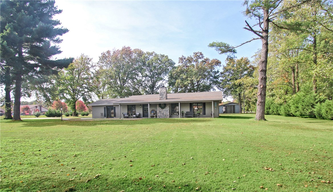 FABULOUS RANCH STYLE PROPERTY IN THE HEART OF THE BENTONVILLE MUSEUM DISTRICT!  Enjoy rural living on 2.57 acres in the middle of town in a beautifully updated 4 bed/3 bath home featuring 2 master suites, 2 living areas, stunning galley kitchen w/ granite and high end stainless appliances, beautiful custom windows, wood flooring and open floor plan great for entertaining.  60 x 38 barn with tack room is home for the horses.  A unique property within walking distance to Crystal Bridges and bike trails and close to all that Bentonville has to offer!