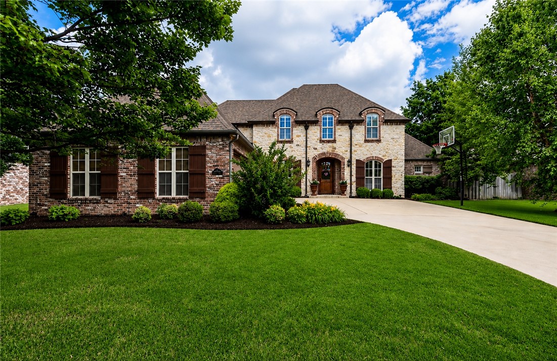 Beautifully maintained 4-bedroom, 3.5-bath home with 3,462 SqFt in a quiet, desirable neighborhood. Features include a stone and brick exterior, vaulted ceilings with exposed beams, crown molding, hardwood flooring, and an open layout great for everyday living and entertaining. The living room offers abundant natural light and a floor-to-ceiling fireplace. Kitchen includes granite counters, pantry, stainless appliances, gas cooktop, double ovens, and large island. Floor plan offers 2 bedrooms downstairs, 2 bedrooms upstairs, dedicated office, and bonus room. Primary suite features dual vanities, tiled shower, soaking tub, and generous closet space. Covered outdoor living area, landscaped backyard, and new roof in 2024. Convenient to Rogers schools, Pinnacle Hills, Topgolf, Walmart AMP, shopping, dining, trails, parks, golf, and major employers including Walmart, JB Hunt, and Tyson Foods.